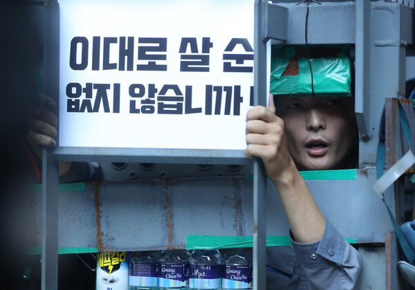 유최안 대우조선 하청지회 부지회장이 지난 7월 19일 경남 거제 대우조선해양 1독에서 '이대로 살 순 없지 않습니까'라는 팻말을 들고 농성하고 있다. (사진=뉴스1)