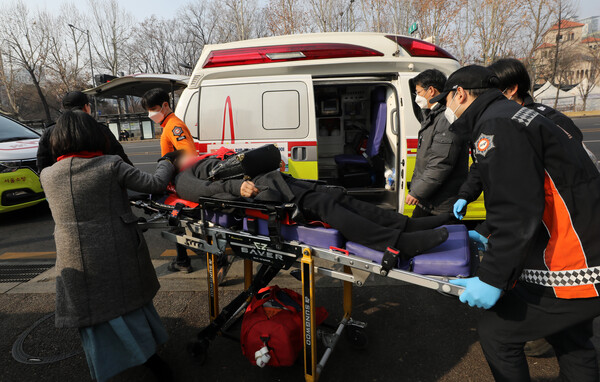 이태원 참사 유가족이 6일 오전 분향소에 전기난로를 들여오려다 제지하는 경찰과 충돌한 뒤 실신해 병원으로 긴급 이송되고 있다. (사진=뉴스1)