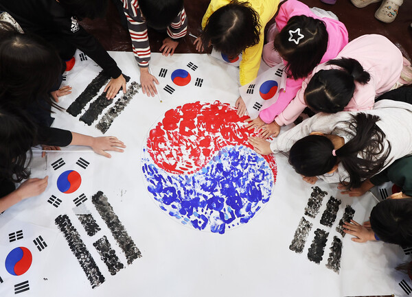 제106주년 3·1절을 이틀 앞둔 27일 경기도 수원시 권선구 세류1동 새마을문고 책먹는 아이들에서 열린 '나라사랑 한마음 손도장 태극기 만들기' 행사에서 어린이들이 손도장 태극기를 만들고 있다. (사진=연합뉴스)