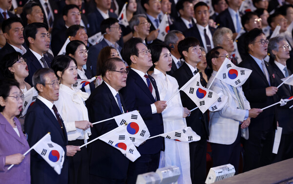 이재명 대통령과 김혜경 여사가 15일 서울 세종문화회관에서 열린 80주년 광복절 경축식에서 참석자들과 함께 태극기를 흔들며 광복절 노래를 제창하고 있다. (사진=연합뉴스)